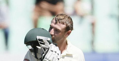 Hughes kisses his helmet after reaching a maiden Test century