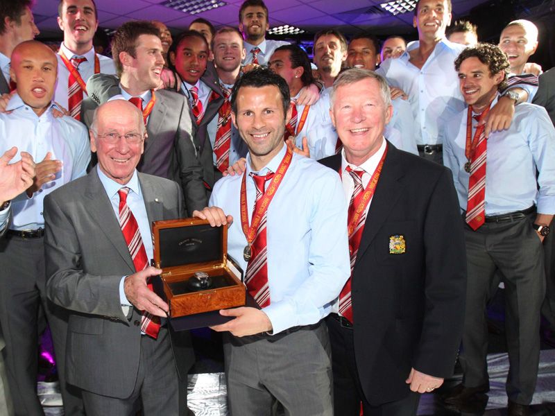 Sir Bobby Charlton presents Giggs with a watch after the winger broke the record for United appearances in the final in Moscow