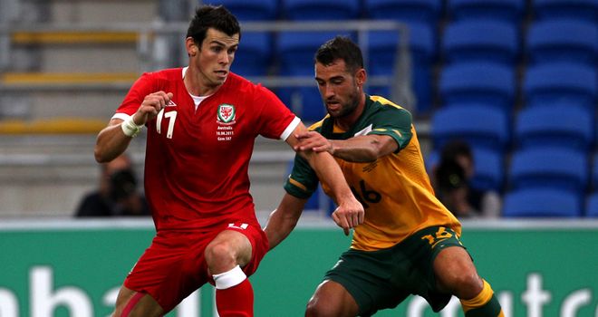 Challenge: Tricky Spurs winger Bale holds off the ball from Valeri at the Cardiff City Stadium