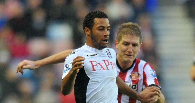 Challenge: Moussa Dembele holds off the attentions of Michael Turner in the Stadium of Light encounter