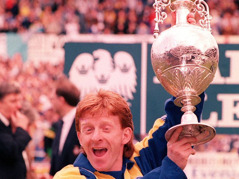 Gordon Strachan hoists the championship trophy as Speed plays a key part in Leeds' 1992 title success