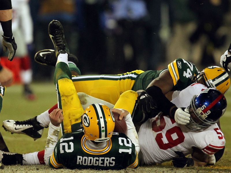 Packers quarterback Aaron Rodgers was sacked four times as the defending Super Bowl champions slumped to a shock 37-20 defeat.