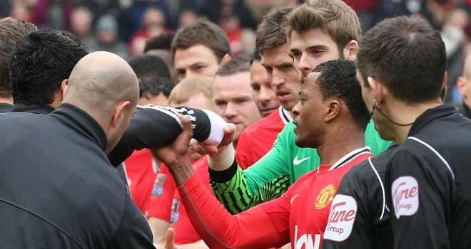 Patrice Evra grabbed the arm of Luis Suarez after the Liverpool striker refused to shake hands