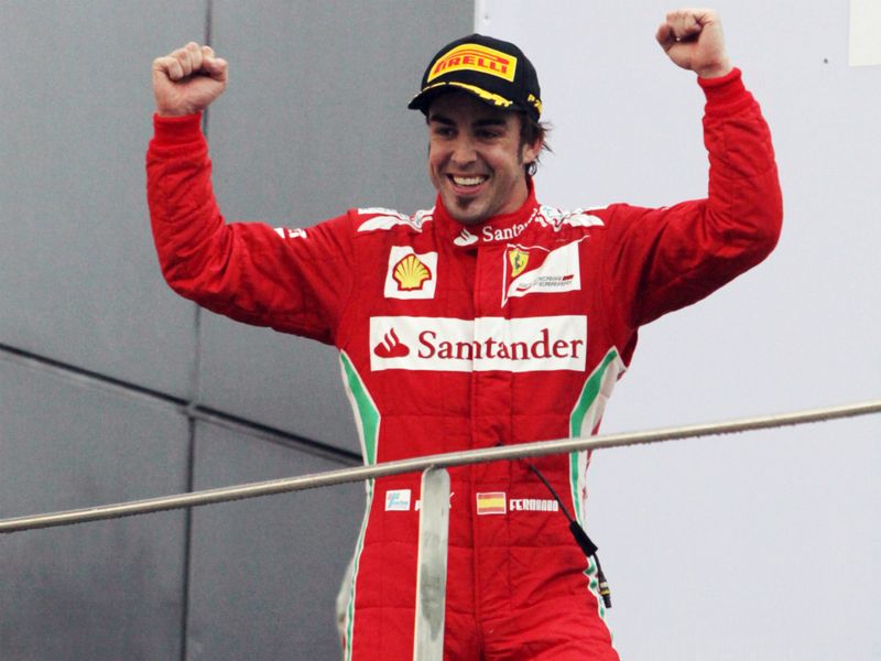 Fernando Alonso celebrates on the podium