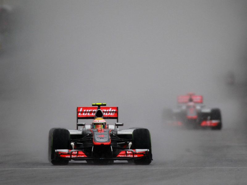 Lewis Hamilton leads Jenson Button in the rain