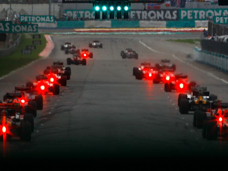 Rain lights are on as the cars head off on the green flag lap