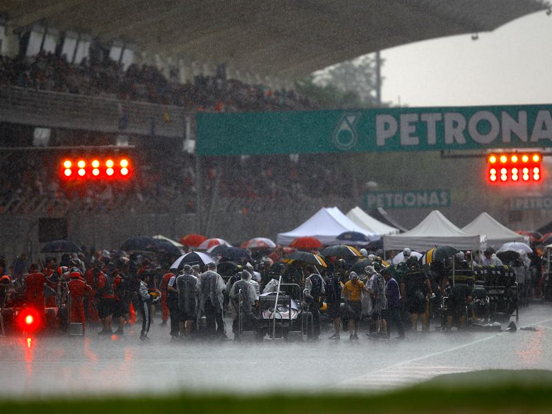 The teams bring out gazebo's to keep the cars dry during the red flag period