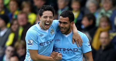 Tevez (r): Celebrates one of his goals against Norwich