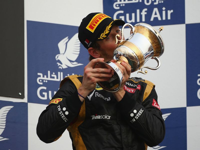 Romain Grosjean kisses the trophy