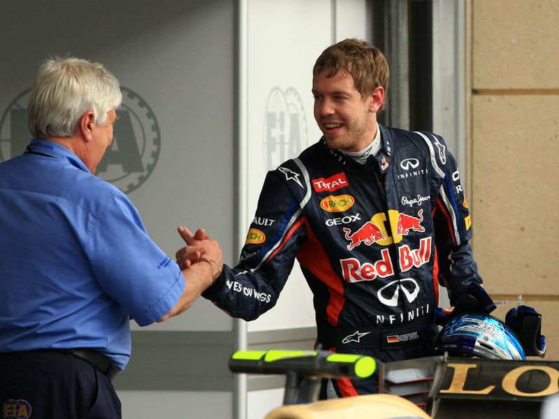 Vettel is congratulated by the FIA