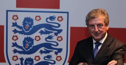 Roy Hodgson poses with the England crest - the famous Three Lions - after being unveiled as manager on Tuesday.