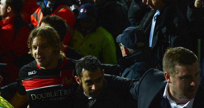 Alan Smith: Is helped from the field by Karl Robinson after being attacked by fans