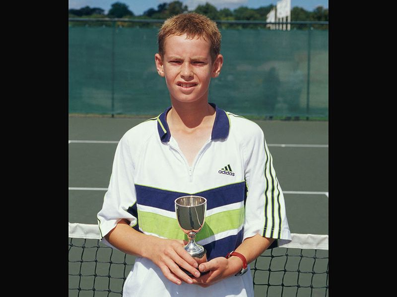 Here he poses with the trophy after winning the U14s Junior National Championships tournament at the age of 12.
