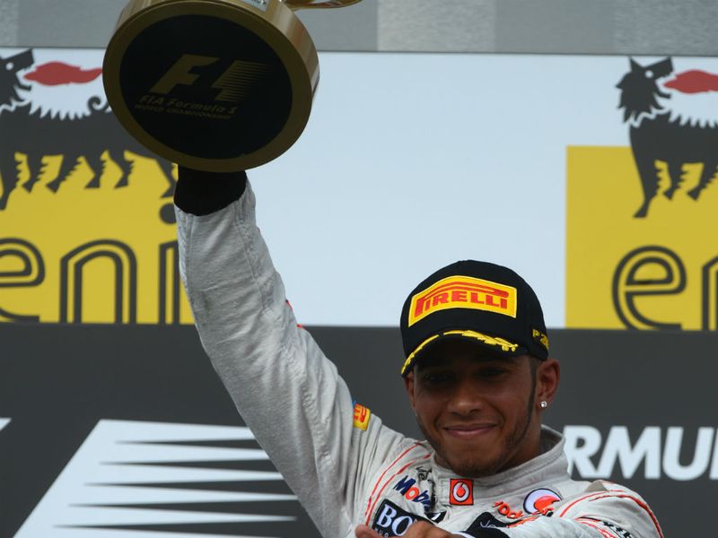 Lewis holds the trophy aloft