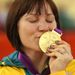 Meares gets acquainted with her gold medal...