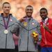 Ashton Eaton of the USA picks up his Gold medal after winning the Men's Decathlon on Thursday. He is joined on the podium by fellow Americ