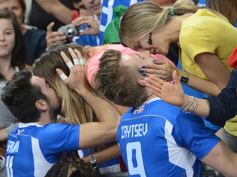 Well done! Italy's Michal Lasko (l) and Ivan Zaytsev kiss their girlfriends after defeating Bulgaria in the men's volleyball bronze medal match