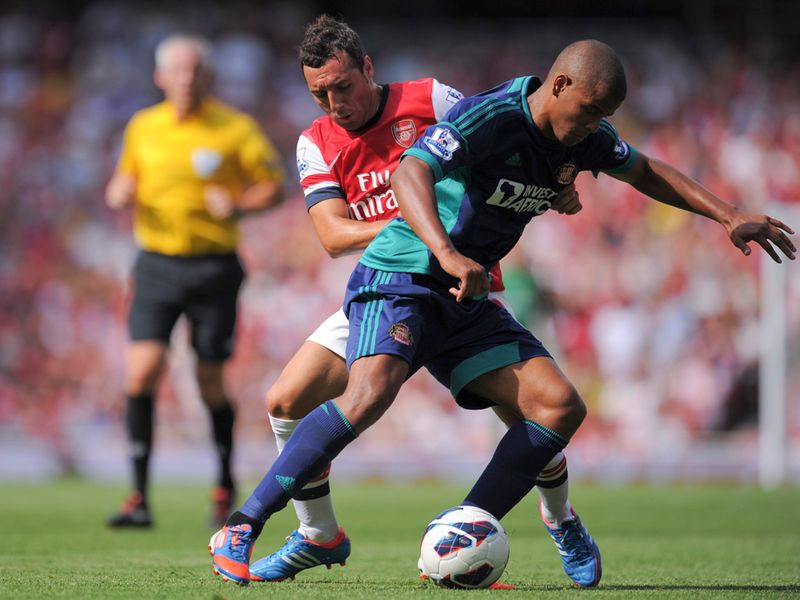 Santi Cazorla tried to tackle Frazier Campbell at the Emirates Stadium.