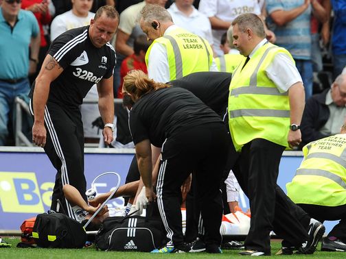 Neil Taylor is loaded onto the stretcher