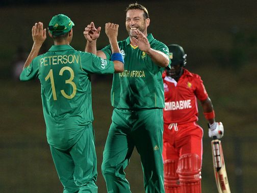Jacques Kallis: celebrates one of his four wickets as Zimbabwe laboured to 93-8