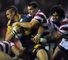 Rhinos forward Ian Kirke is tackled by Matty Smith