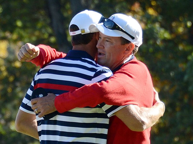 Dustin Johnson is congratulated by Davis Love III after he beats Colsaerts by 3 and 2.