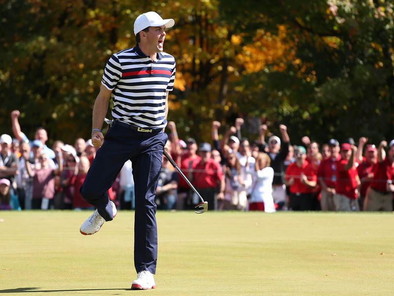 Bradley celebrates after holing a birdie on the fifth to stay in touch with Rory.