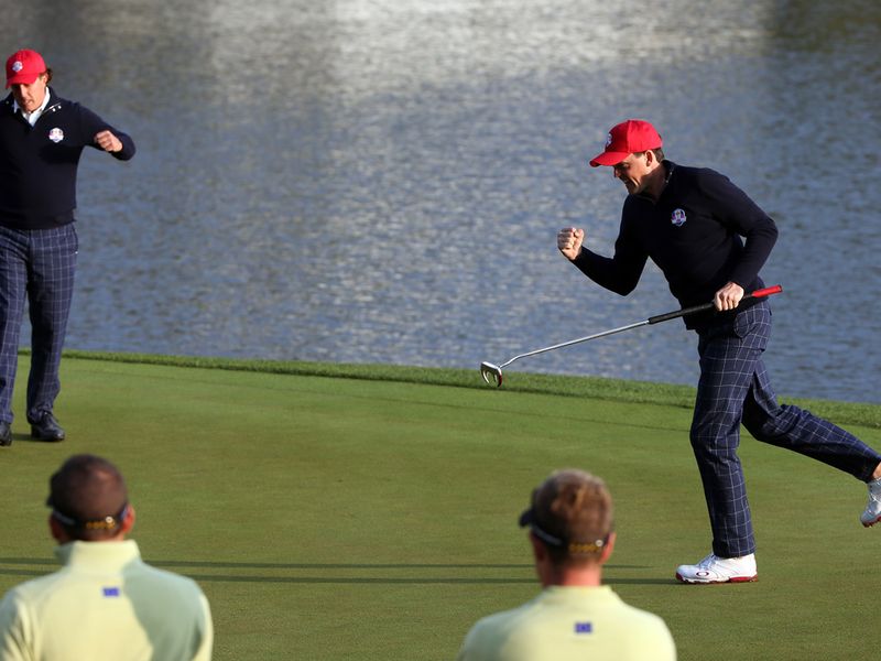 Keegan Bradley and Phil Mickelson celebrate a birdie putt on the second.
