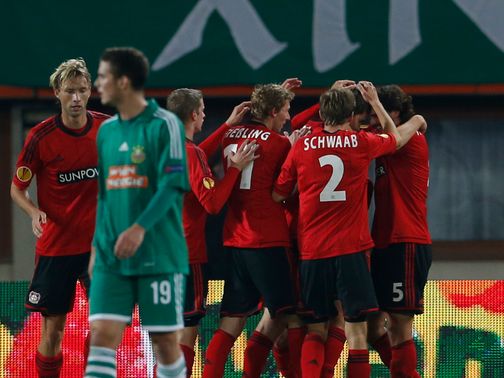 Philipp Wollscheid is mobbed after giving Leverkusen the lead