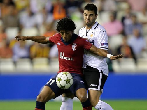 Ball control: Valencia beat Lille 1-0 in their final Champions League Group F match, but qualify as runner-up as Bayern Munich beat BATE Borisov.