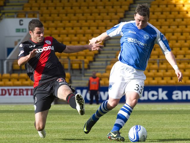 Lewis Guy slides in on Tam Scobbie.