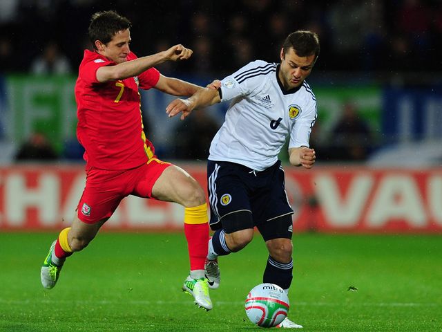 Joe Allen tries to stop Shaun Maloney.