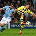 Edin Dzeko and Mats Hummels battle for the ball at the Etihad Stadium