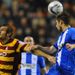 Bradford's James Hanson vies for the ball with Wigan defender Piscu at the DW Stadium.