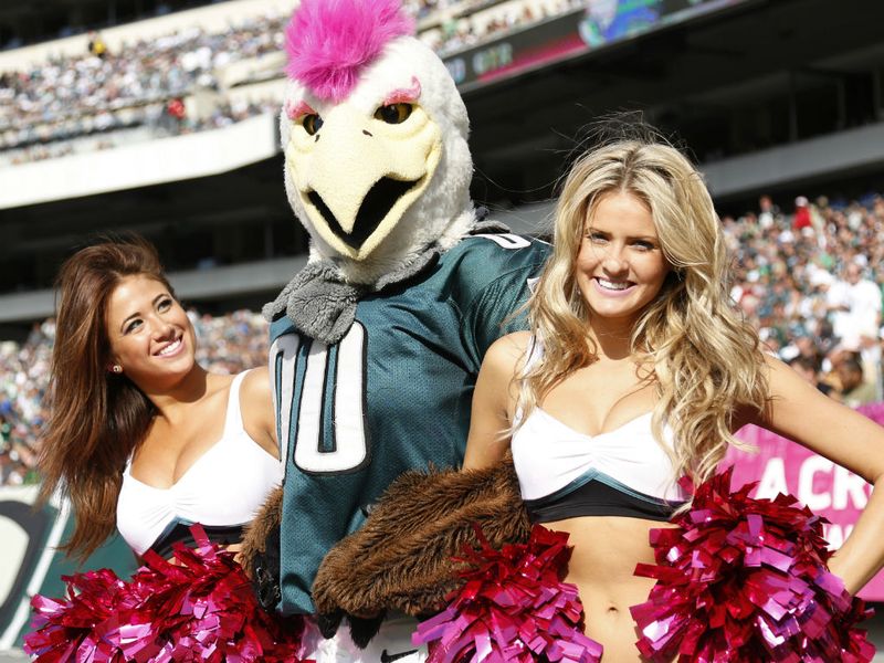 The Philadelphia Eagles mascot enjoys a photo with the cheerleaders.