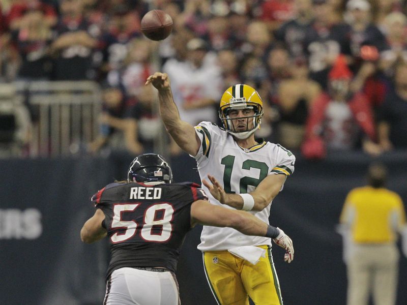 Aaron Rodgers threw six TDs as his Green Bay Packers inflicted a first defeat on Houston in emphatic style.