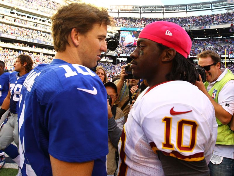 Quarterbacks Eli Manning and Robert Griffin III chat after the game