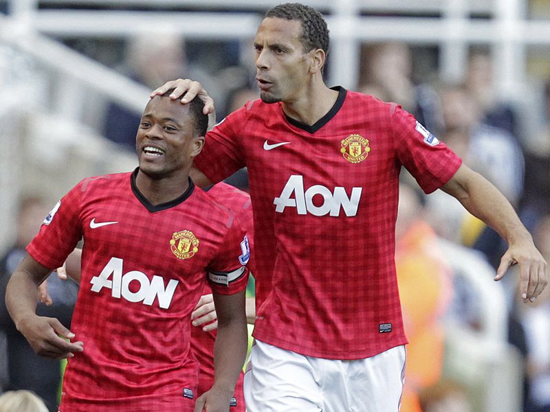 ...but Patrice Evra is all smiles after scoring midway in the second period.