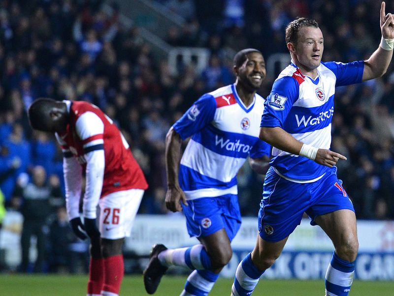 Arsenal's Emmanuel Frimpong cuts a dejected figure as Noel Hunt adds Reading's fourth first-half goal.