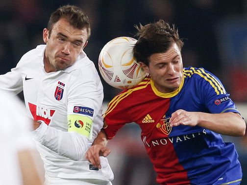 Gyorgy Sandor and Valentin Stocker battle for the ball