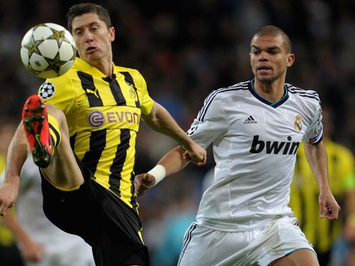 Robert Lewandowski brings the ball down as Pepe looks on