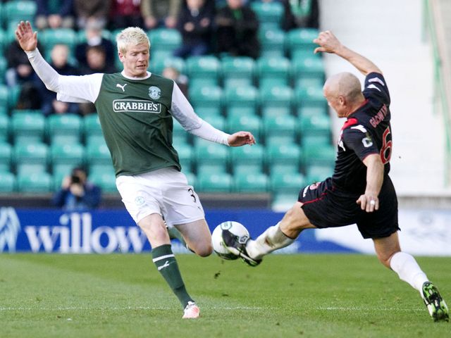 Ryan McGivern and Jim Goodwin battle for the ball