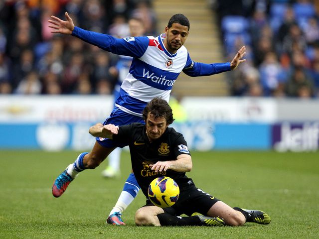 Jobi McAnuff and Leighton Baines battle for the ball