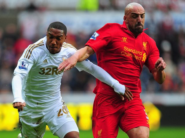 Jonathan de Guzman and Jose Enrique battle for the ball