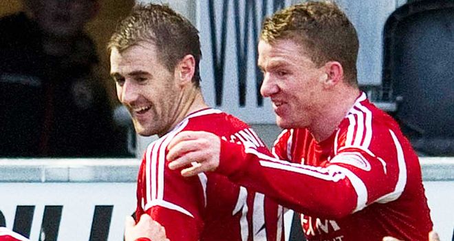 Niall McGinn (left) celebrates his magnificent seventh league goal in succession