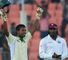 Abul Hasan celebrates his debut hundred as Chris Gayle (background) applauds
