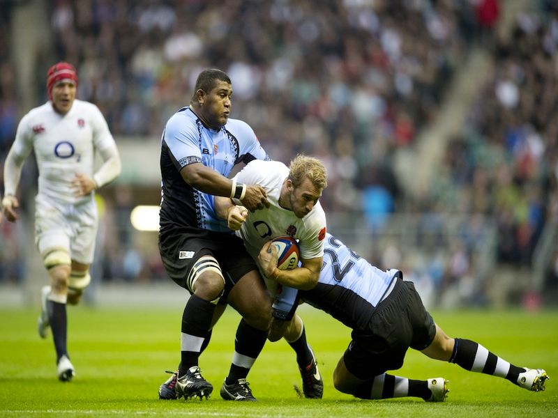 Captain Chris Robshaw is wrapped up by Fiji tacklers