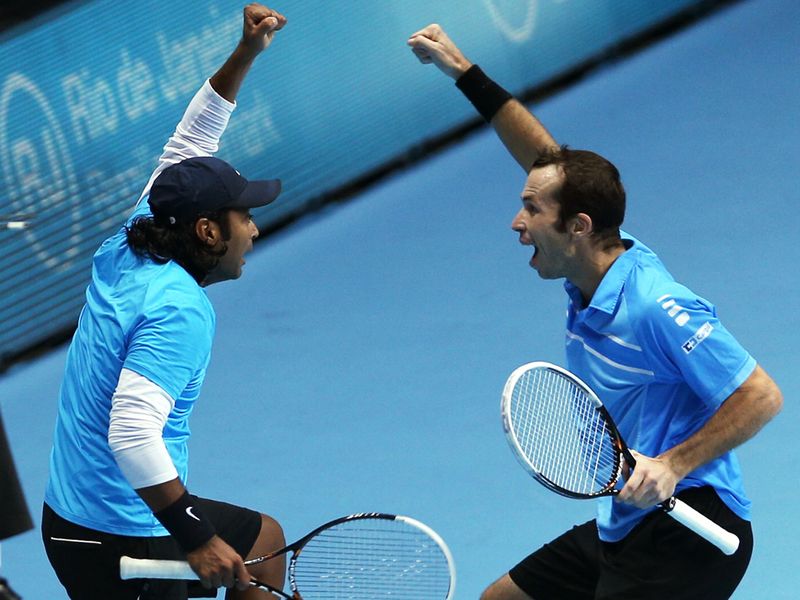 Leander Paes and Radek Stepanek celebrate their win in the doubles over Marcel Granollers and Marc Lopez in the first match of the day.