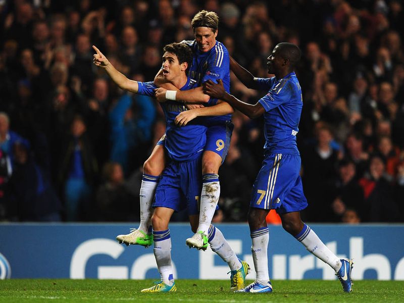 Torres helps Oscar celebrate his superb goal.