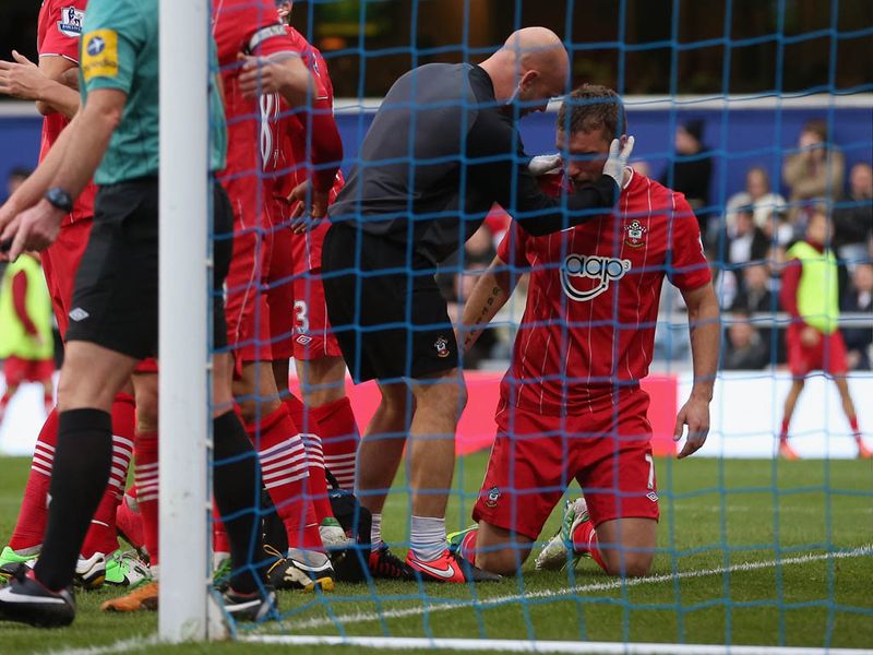 Lambert receives treatment after taking a foot to the head in the build-up to his goal.